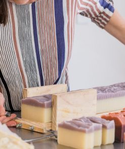 Lanae Rhoads cutting a fresh batch of handmade petals and patchouli soap