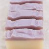 three bars of petals and patchouli handmade organic soap purple and white layers with cornflower petals for cleansing skin with essential oils