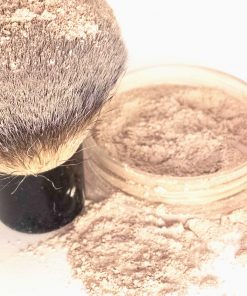 Custom-matched mineral foundation in a sleek jar with powder spilling elegantly.