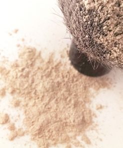 Makeup brush in loose foundation powder, highlighting Skin-nourishing and Natural sun-protection properties