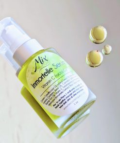 Immortelle Facial Serum Vitamin C facial oil on a mirror infused with Tetrahexadecyl Ascorbate and Organic rosehip oil it is good for acne but it will also give Plump, youthful skin with a Lightweight texture for glowing skin