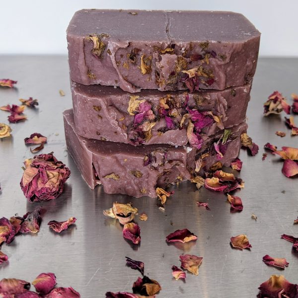 three bars of organic handmade soap colored with rosehip powder and rose petals scented with mulled cider fragrance a deep burgundy plum color from beet juice with essential oils of orange patchouli and ylang ylang