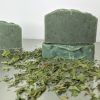 three bars of handmade vanilla mint soap with organic ingredients including stinging nettles and french green clay speckles of green in organic soap all natural ingredients