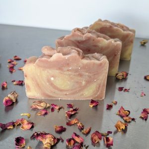 three bars of organic handmade soap with rose petals and amber resin, rose geranium essential oil and swirled with pink and white clay