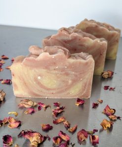 three bars of organic handmade soap with rose petals and amber resin, rose geranium essential oil and swirled with pink and white clay