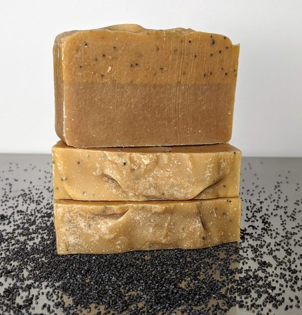 three bars of lemon poppy seed handmade organic soap with poppy seeds on the table scented with vanilla, citrus, lemon essential oils for brightening skin and removing odors