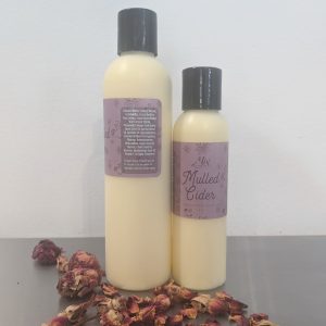 organic, moisturizing mulled cider body lotion for fall made with essential oils with a plum colored label made with essential oils