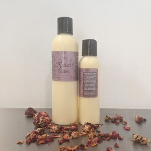 organic moisturizing mulled cider body lotion with plum label, rose petals and scented with essential oils
