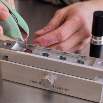pouring custom lipstick into the mold at Mix Cosmetiques where personalized cosmetics are made