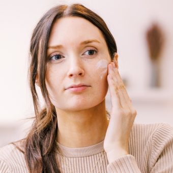 woman using tinted everything all day optimizing cream