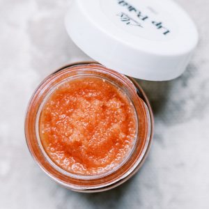 open jar of fresh berry lip scrub and lip polish made with organic freeze dried strawberries to show consistency