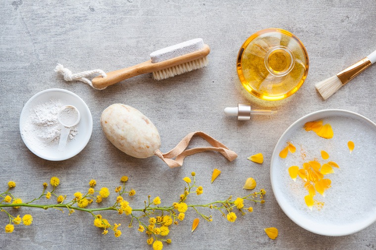 bath oil and scrubbers amidst florals