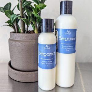 paraben-free phalate-free organic lotion for natural skin care with bergamot scent next to green zz plant in concrete pot
