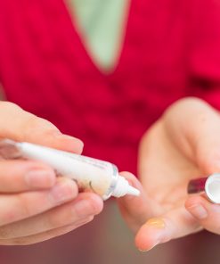 a teenager showing how to use green apple zit zap out of the tube for gentle, botanical teen acne care with green apple extract for natural blemish treatment
