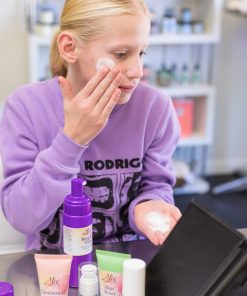 teen using Gentle teen facial cleanser with cucumber extract for hydration and soothing skin.