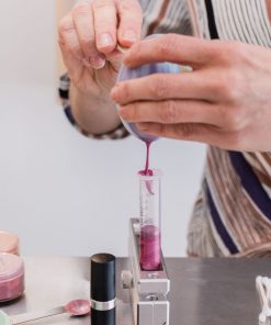 pouring a custom personalized lip gloss at the lip gloss lab buildable color gloss, with a glossy finish sustainable cosmetics safe for clean beauty and cruelty-free,
