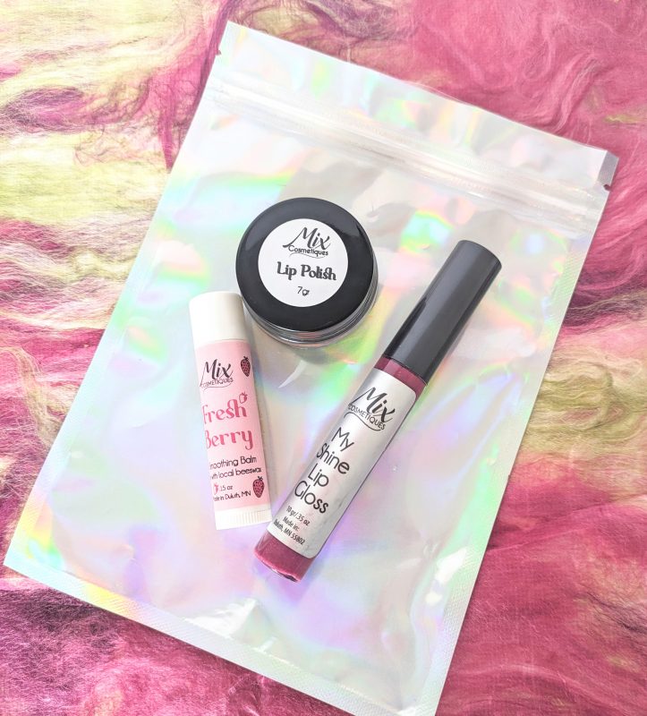 Ultimate Holiday lip care gift set includes Organic lip gloss, full size lip balm, and mini lip polish kit in fresh berry an Eco-friendly holiday beauty gift option and a fun Lip care stocking stuffer for Smooth, hydrated lips