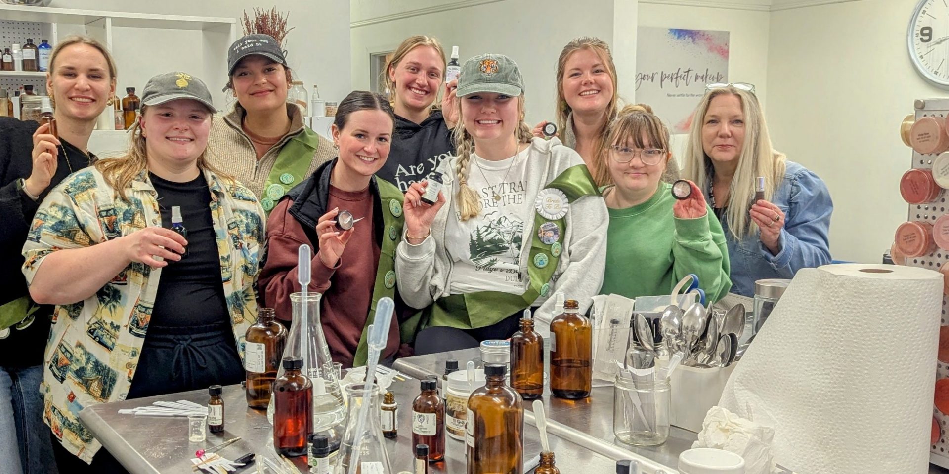 Bride and bridesmaids creating bespoke perfume during a unique hands-on bachelorette party.