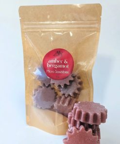 Amber Bergamot Micro Scrubbies in pale burgundy, sunshine-shaped solid scrub bars arranged on a clean white background.